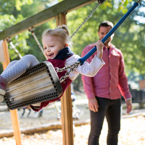 happy kid on a swing | HOA playground safety