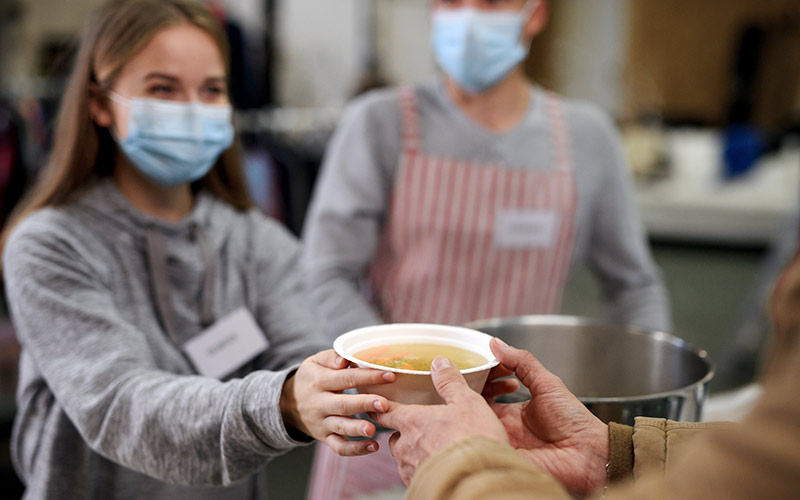 volunteer giving soup | volunteer at a soup kitchen