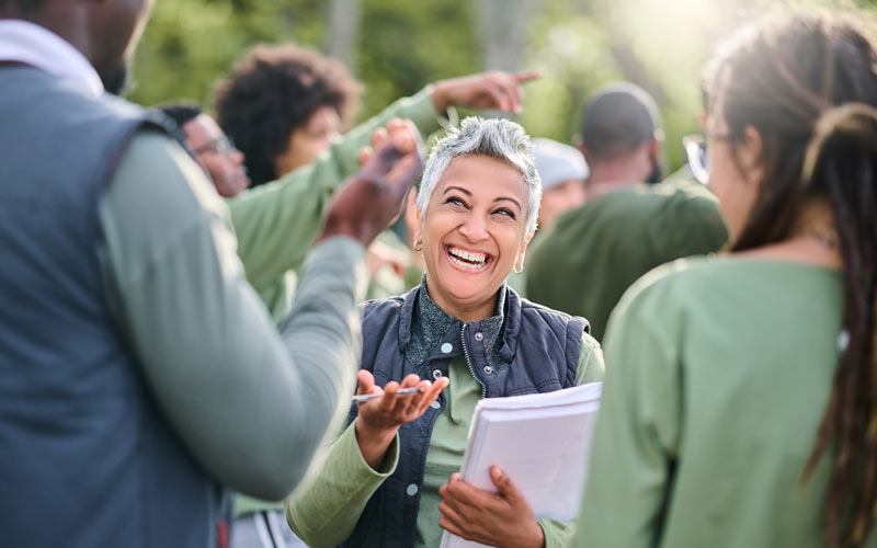 happy woman organizing | community block party ideas