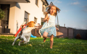 girl playing with dog | heat stroke in dogs