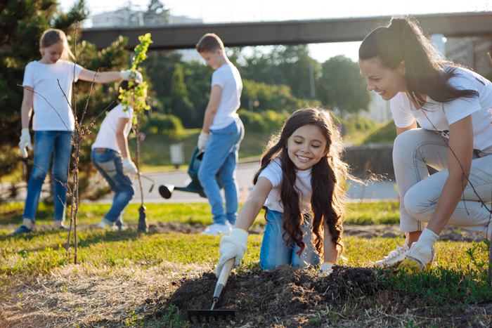 teaching children to plant trees | HOA spring planting